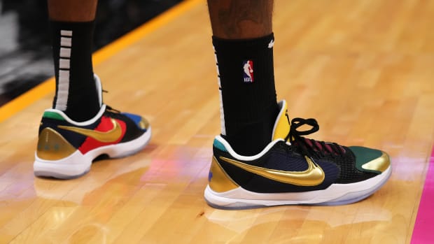 View of black and gold Nike Kobe shoes.